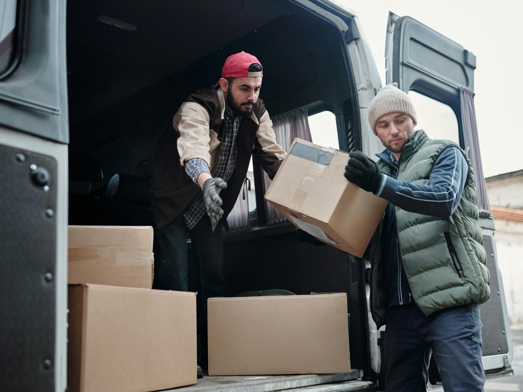 Team loading boxes into a cargo van